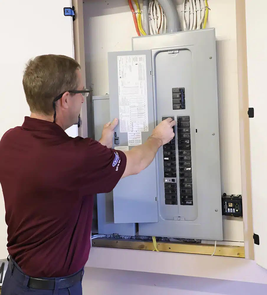 Technician checking electrical panel in Warrenton, VA.